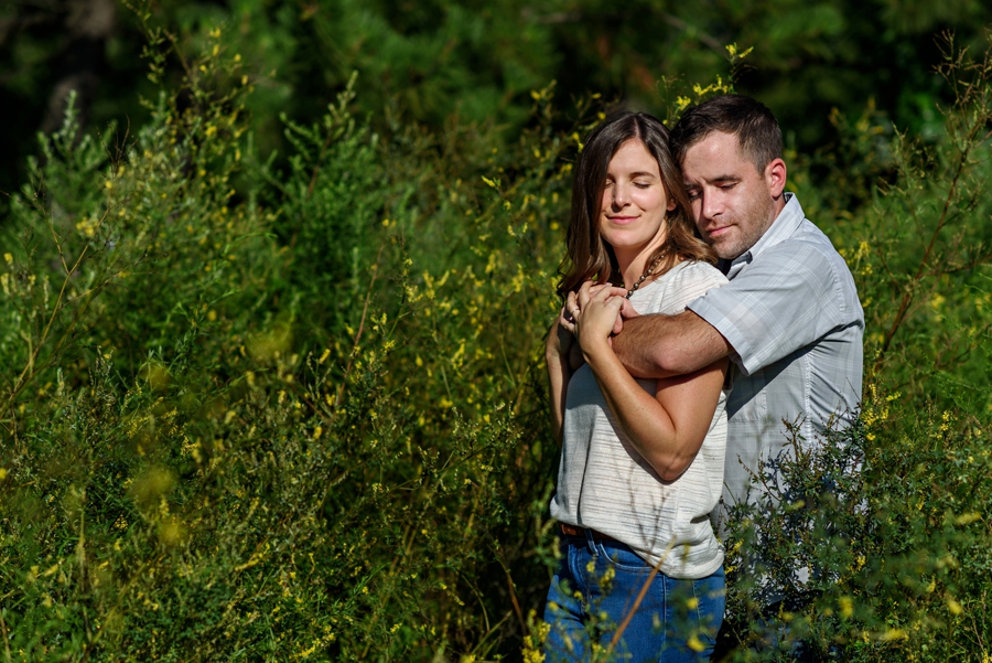 A man holds his fiance in the sun.